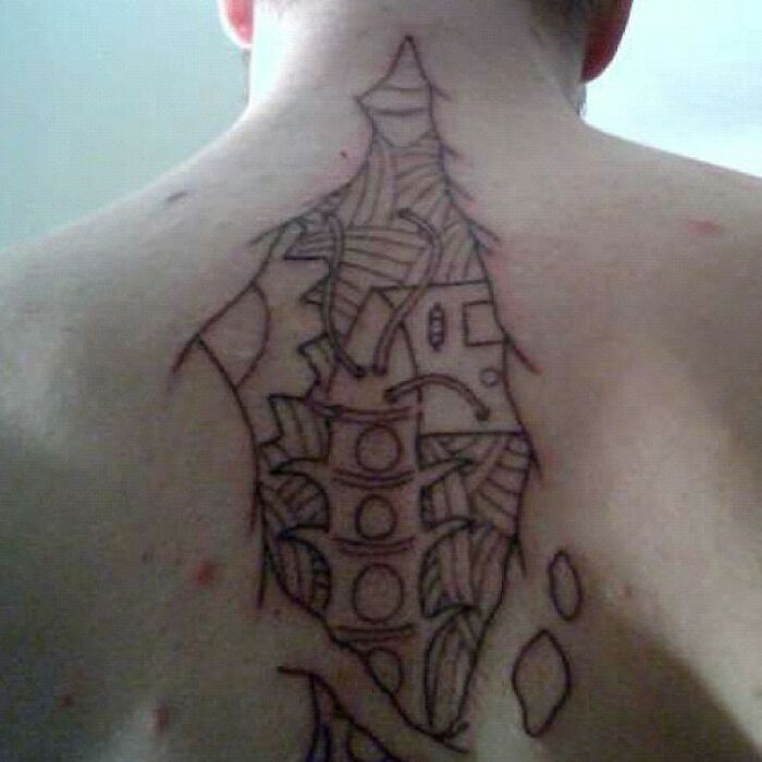 "Back tattoo with abstract design, showcasing one of many funny tattoo fails."