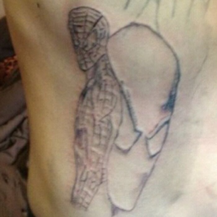 Funny worst tattoo fail featuring a poorly drawn superhero design on skin.