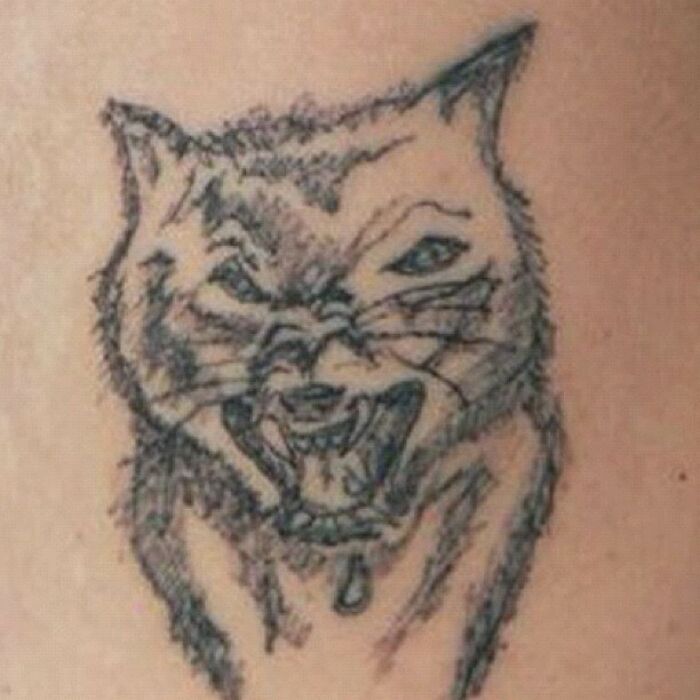 Sketchy cat with uneven lines, an example of funny worst tattoo fails.