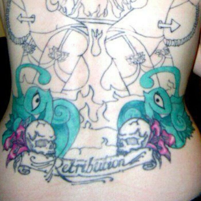 Back tattoo featuring whimsical illustrations and the word "Retribution," showcasing a funny tattoo fail.