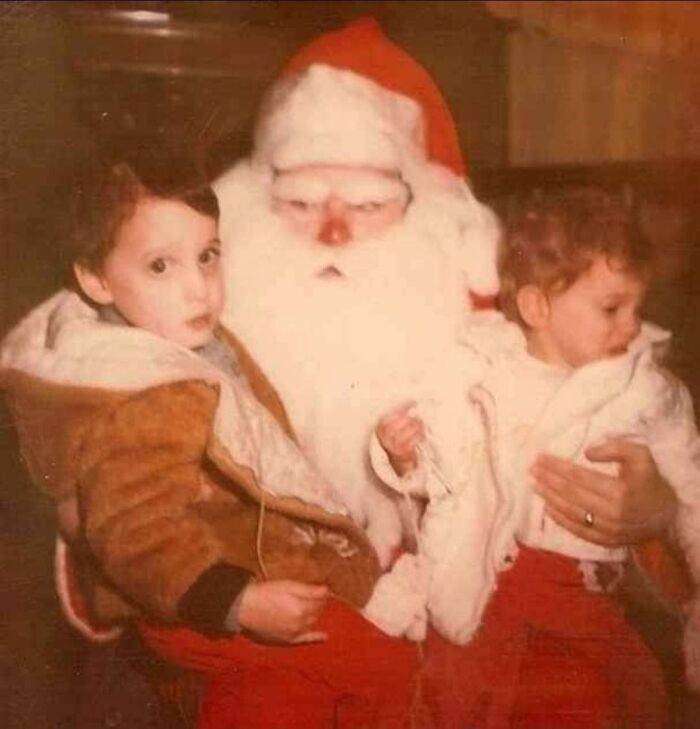 Children sitting with a creepy Santa in a vintage photo.