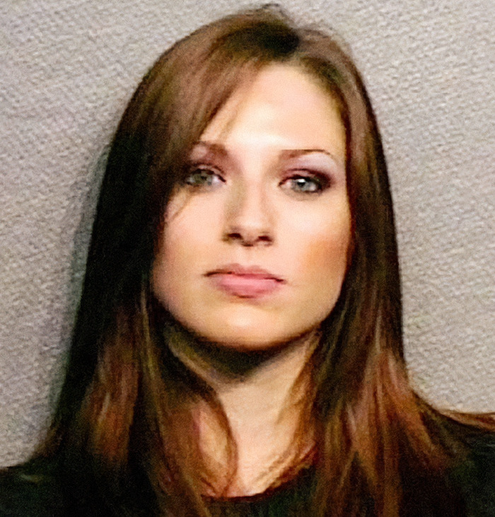 Viral mugshot of a woman with brown hair and striking eyes, part of the criminal heartthrobs trend.