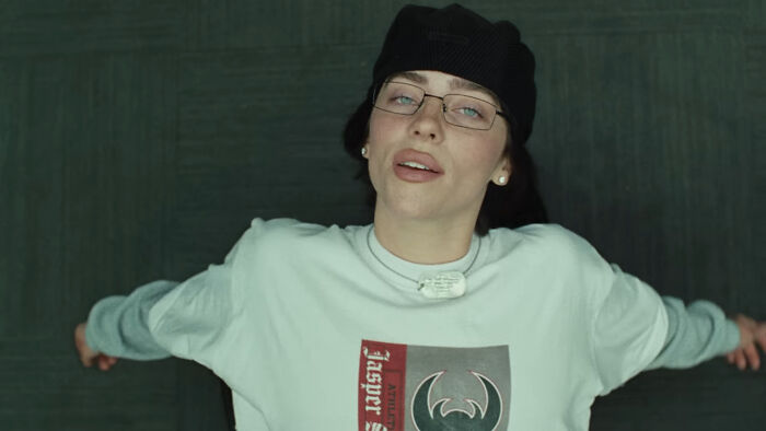 Person in a white shirt and glasses, lying down, embodying 2024 people list trends.