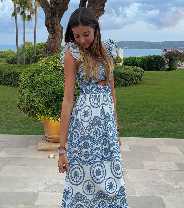 French countess Alieson Loppin de Montmort in a patterned dress at an outdoor event, embodying elegance; the setting includes lush greenery and an ocean view. French countess Alieson Loppin de Montmort in a patterned dress at an outdoor event, embodying elegance; the setting includes lush greenery and an ocean view.