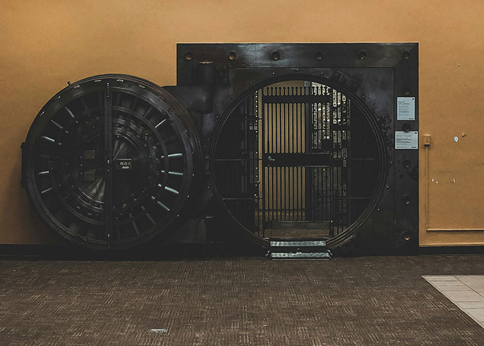 Vintage bank vault door seen in someone's home, creating a surprising interior feature.