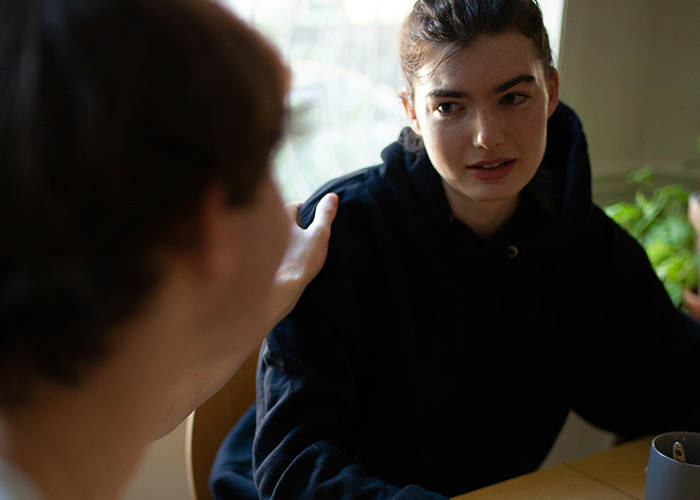 Woman expressing resentment to her partner, sparking a tense discussion over an unequal gift exchange.