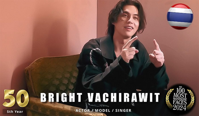 Actor and model, ranked among the most handsome men of 2024, smiling seated on a patterned chair.