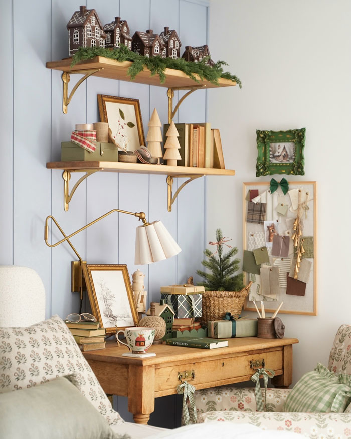 Cozy room with Christmas-decorating-ideas: gingerbread houses, festive shelves, small Christmas tree and wrapped gifts.