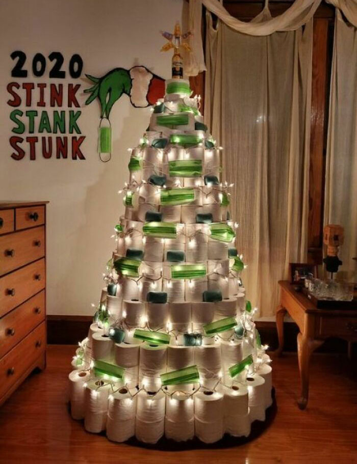 Creative Christmas tree idea made from stacked toilet paper rolls with lights and green accents.