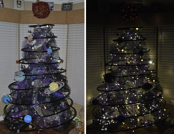 Unique Christmas tree idea with a black spiral design decorated with planets and glowing lights.