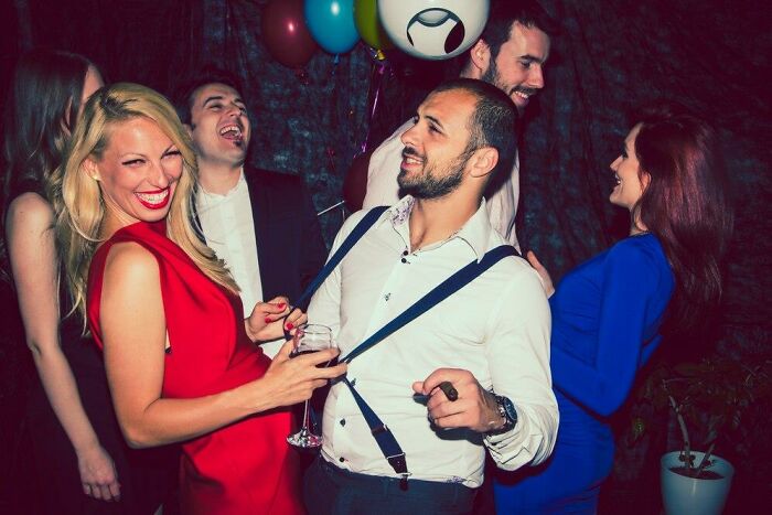 Guests laughing and dancing at a wedding party.