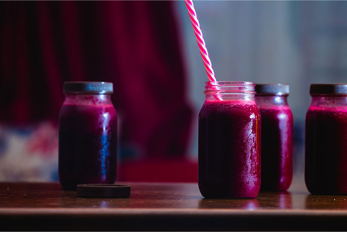 Jars of purple juice with a straw, illustrating a crazy body life hack idea.