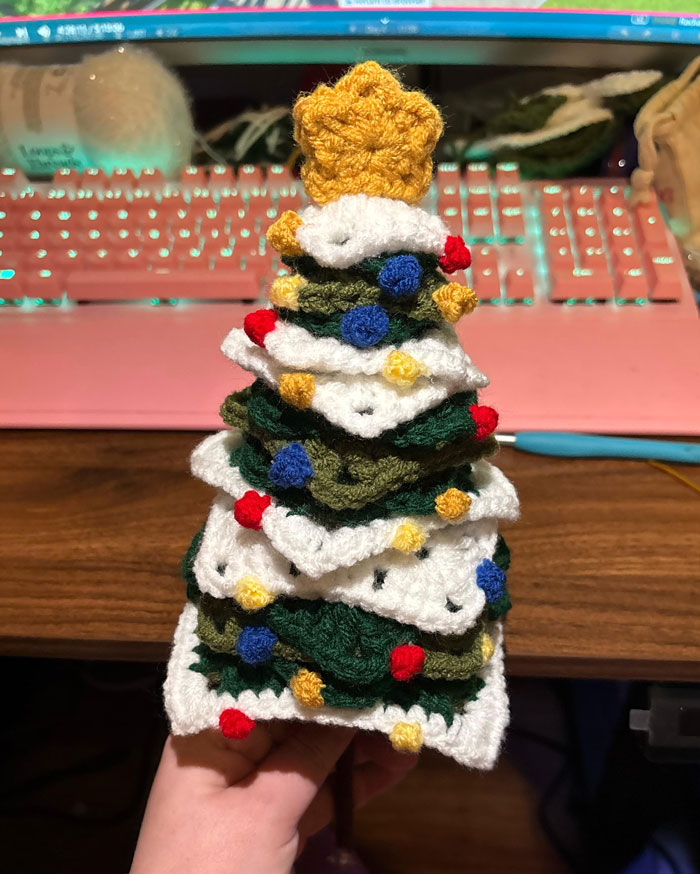 Crocheted Christmas tree with colorful decorations, showcasing creative DIY Christmas decorations on a desk.