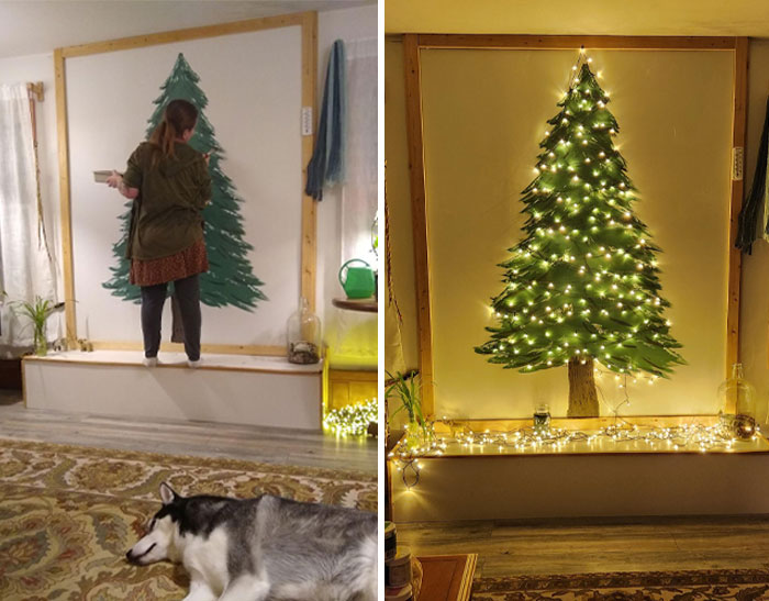 Person painting a Christmas tree mural on the wall for creative DIY Christmas decorations, with lights added.