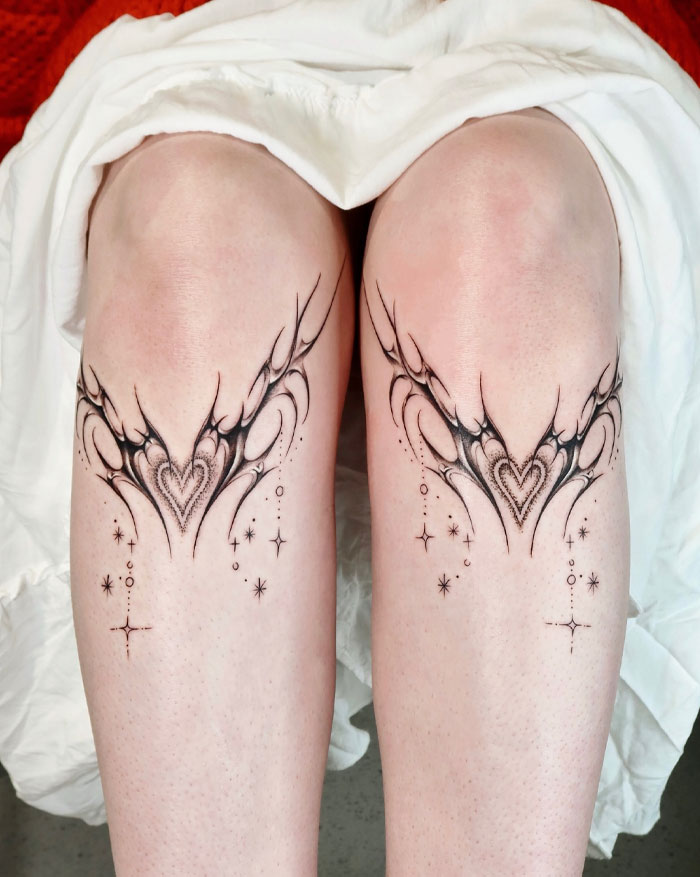 Cybersigilism tattoo designs on knees showcasing intricate symbols and patterns in black ink.