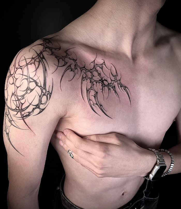 Tattoo design showcasing cybersigilism style on a person's shoulder and arm.