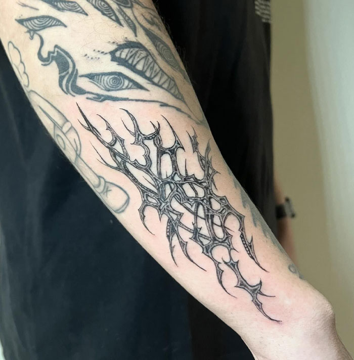 Cybersigilism tattoo design on forearm, showcasing intricate patterns and symbolism.