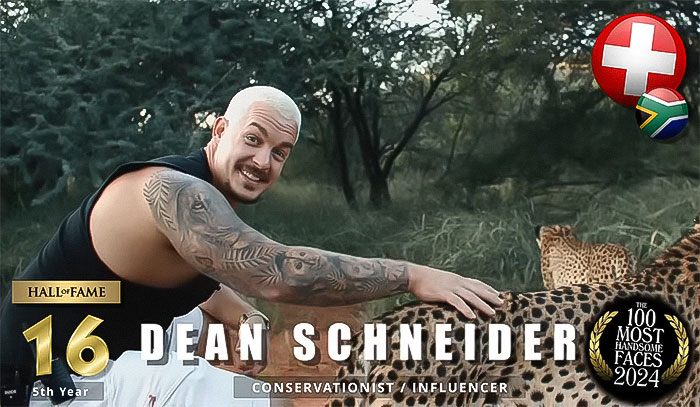 Man smiling with a cheetah, ranked in The Most Handsome Men of 2024 list, showcasing tattoos outdoors.