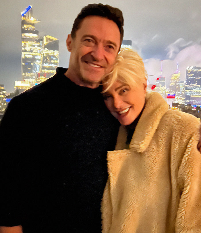 Hugh Jackman poses with an unidentified woman against a city skyline, sparking rumors. Hugh Jackman poses with an unidentified woman against a city skyline, sparking rumors.