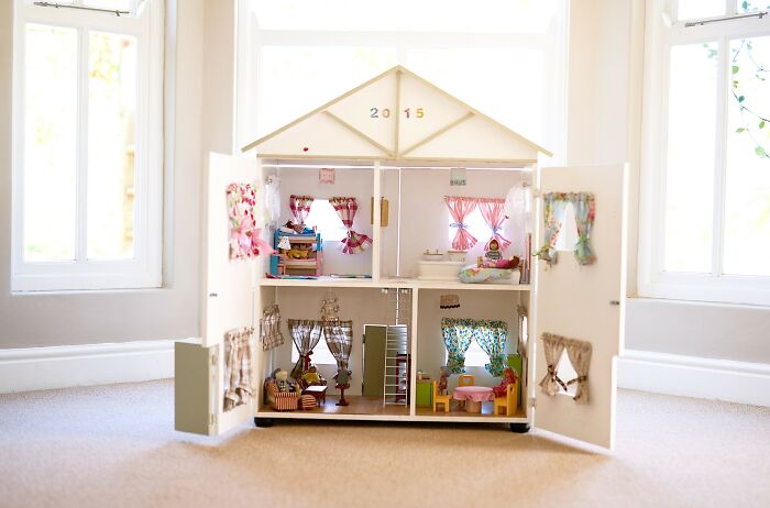 Dollhouse interior with colorful miniature rooms, reflecting Pinterest's 2025 trend predictions in home decor.