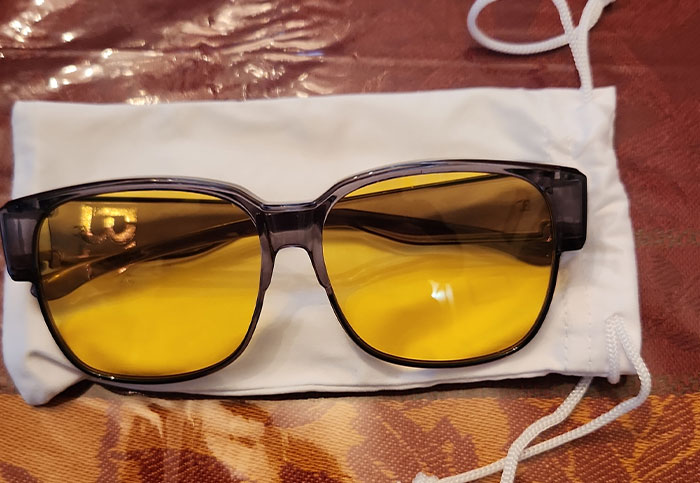 Yellow sunglasses on a white pouch, related to customer queries.