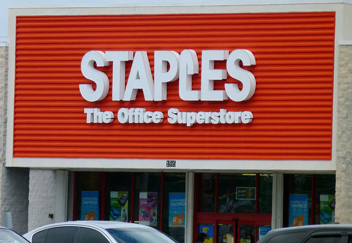 Staples store entrance, showcasing bright orange signage, related to customer questions theme.