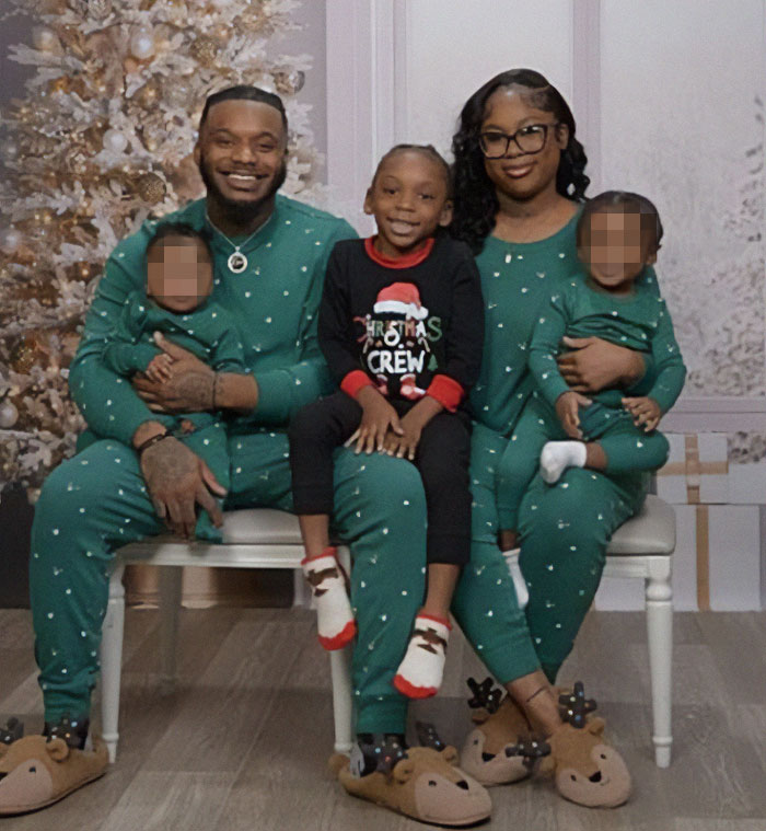 Family in green pajamas with son wearing different Christmas pajamas sitting in front of a decorated tree. Family in green pajamas with son wearing different Christmas pajamas sitting in front of a decorated tree.