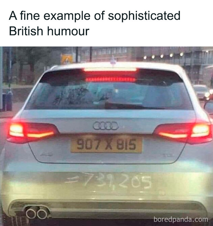 Car shows British humor with a math joke on the rear, scribbled in dust, under a license plate ending in 815.