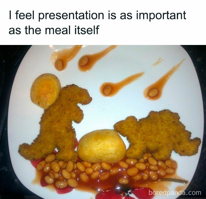 Dinosaur-shaped nuggets with beans and potatoes arranged humorously on a plate.