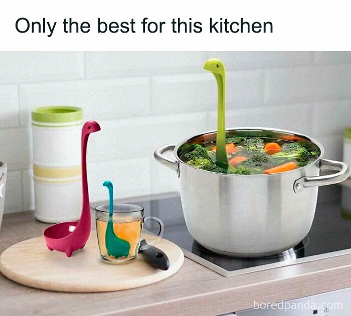 Dinosaur-shaped kitchen tools in pot of soup and tea cup, adding prehistoric humor to cooking.