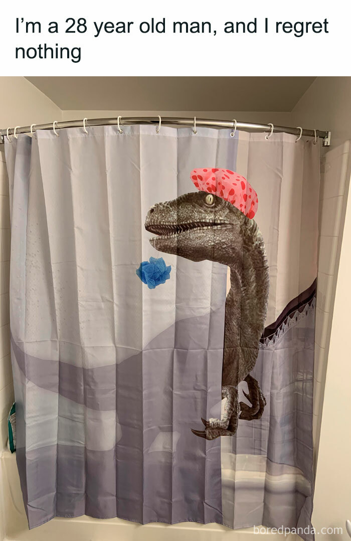 Dinosaur meme: Velociraptor shower curtain with a funny cap in a bathroom setting.