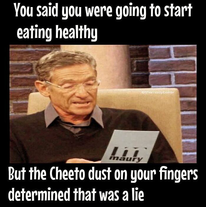 Man reading a card with text caption about dieting frustrations and Cheeto dust.