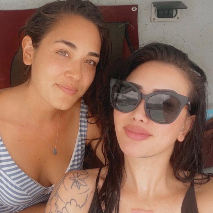 Two women smiling outdoors, one with sunglasses, symbolizing a focus on healing. Two women smiling outdoors, one with sunglasses, symbolizing a focus on healing.