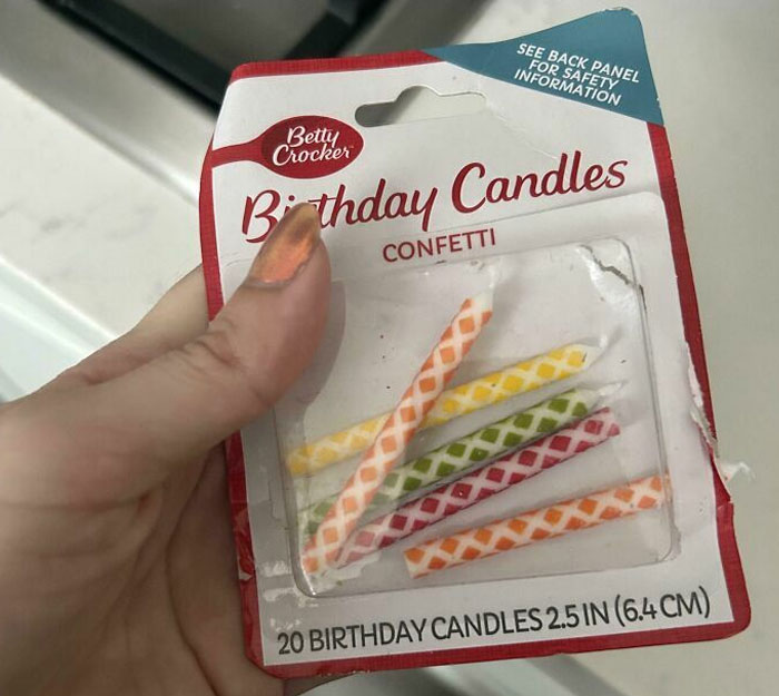 A hand holding an empty pack of Betty Crocker birthday candles, fitting the theme of horrible roommates.
