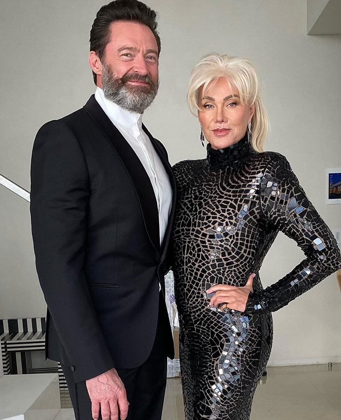 Man in a tuxedo with a mysterious woman in an elegant dress, sparking rumors. Man in a tuxedo with a mysterious woman in an elegant dress, sparking rumors.