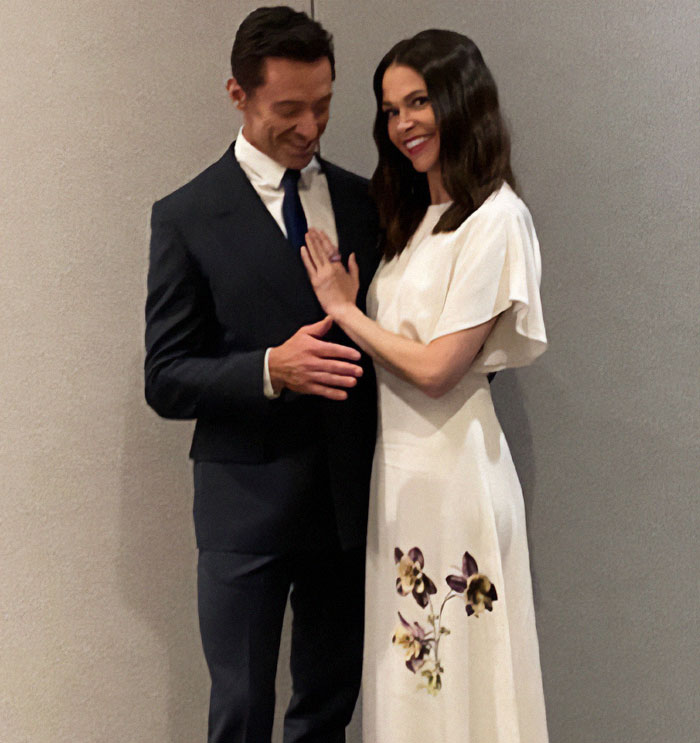 Hugh Jackman with a woman in a white dress, sparking rumors. Hugh Jackman with a woman in a white dress, sparking rumors.