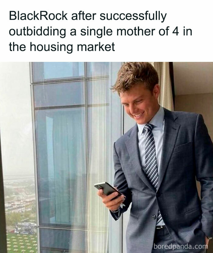 Man in a suit smiling at phone; meme about the housing market resembling a funny, unstoppable dumpster fire.