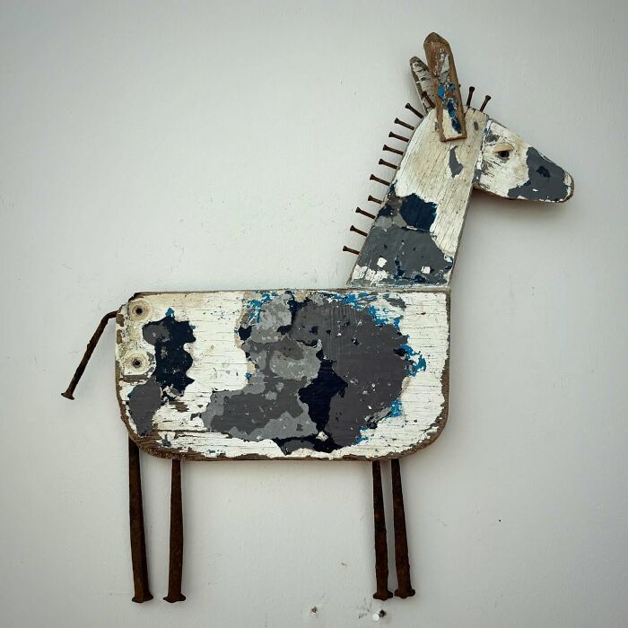A driftwood animal sculpture by Kirsty Elson, featuring a stylized horse made from reclaimed wood with rustic details.