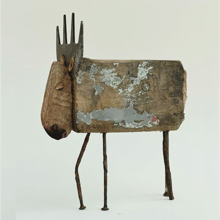 Driftwood animal sculpture with fork antlers, featuring rustic texture and unique craftsmanship.