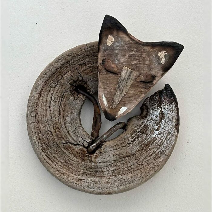 Driftwood animal sculpture resembling a curled fox, crafted by artist Kirsty Elson.