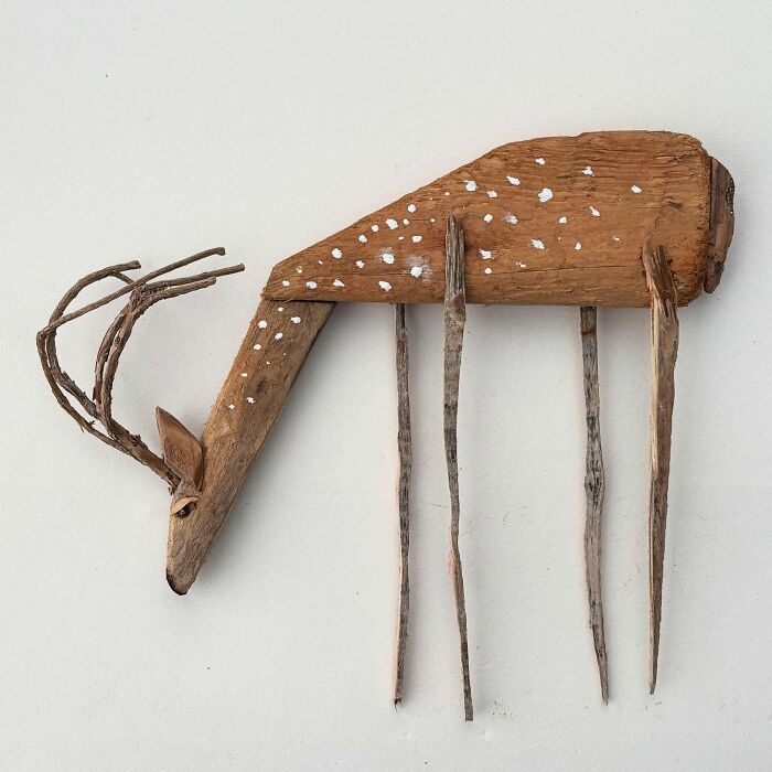 Driftwood sculpture of a deer, showcasing unique artistic design with natural wood texture and form.