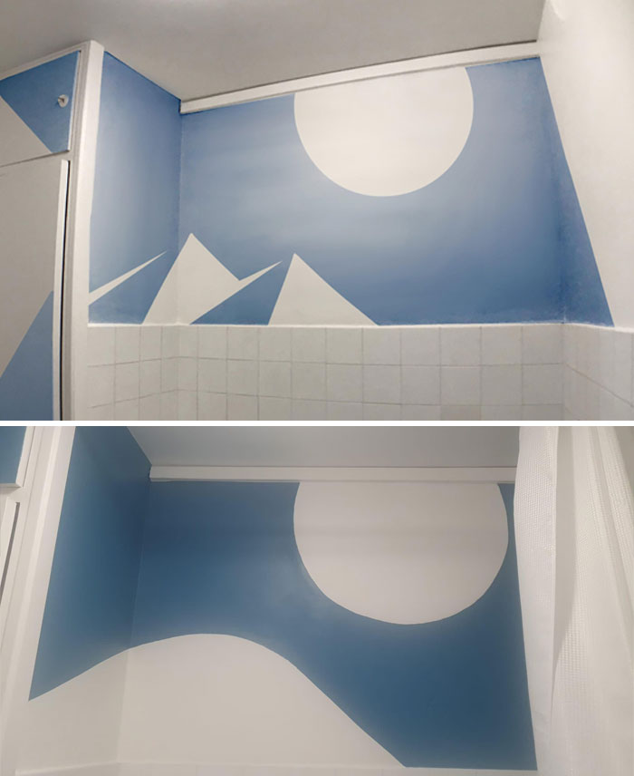Bathroom wall with simple blue and white mountain mural, possibly painted by infuriating family members.