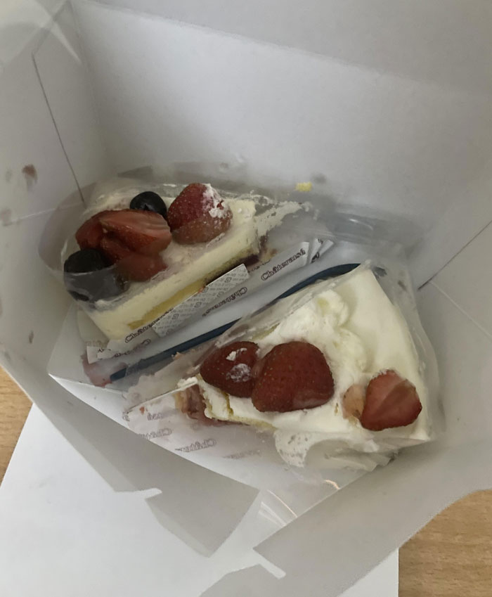 Slices of cake topped with strawberries in a box, related to infuriating family members.