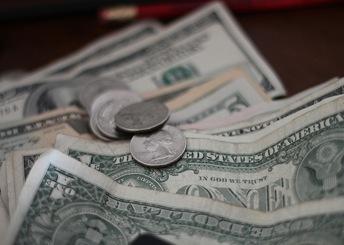 Close-up of dollar bills and coins, symbolizing real-life insurance claims and financial concerns.