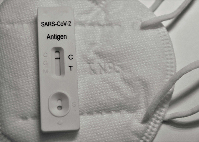 COVID-19 antigen test on an N95 mask, highlighting insurance issues in healthcare scenarios.