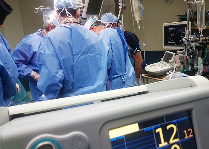 Doctors in a surgery room surrounded by medical equipment, highlighting a real-life insurance horror story scenario.