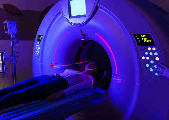 Patient undergoing MRI scan in a dimly lit room, highlighting real-life insurance issues in medical settings.