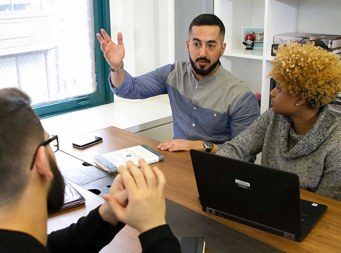 Candidate discusses job expectations and salary with interviewers in a professional setting.