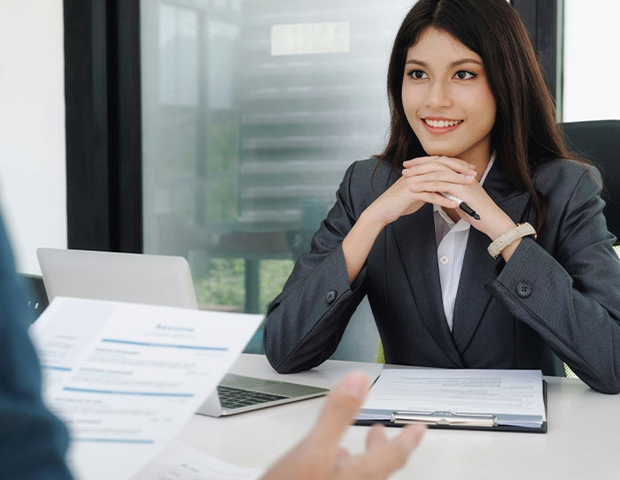 Candidate in a job interview, looking intrigued as expectations and salary are discussed.