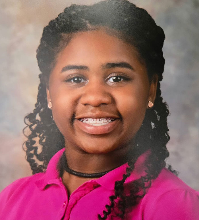 Kelaia Turner smiling with braces and curly hair, wearing a pink shirt, related to bullying and abuse incident. Kelaia Turner smiling with braces and curly hair, wearing a pink shirt, related to bullying and abuse incident.